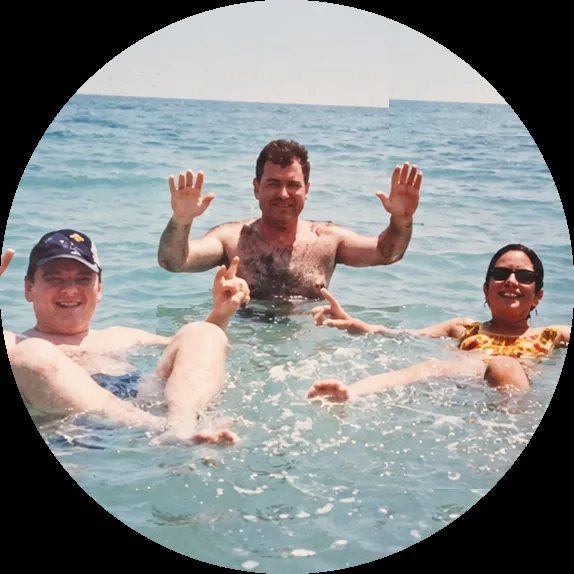 An illustration of a family floating together in the sea with their hands raised